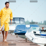 demo-attachment-32-sailor-in-yellow-cloak-at-the-pier-holding-life-PX7M94D